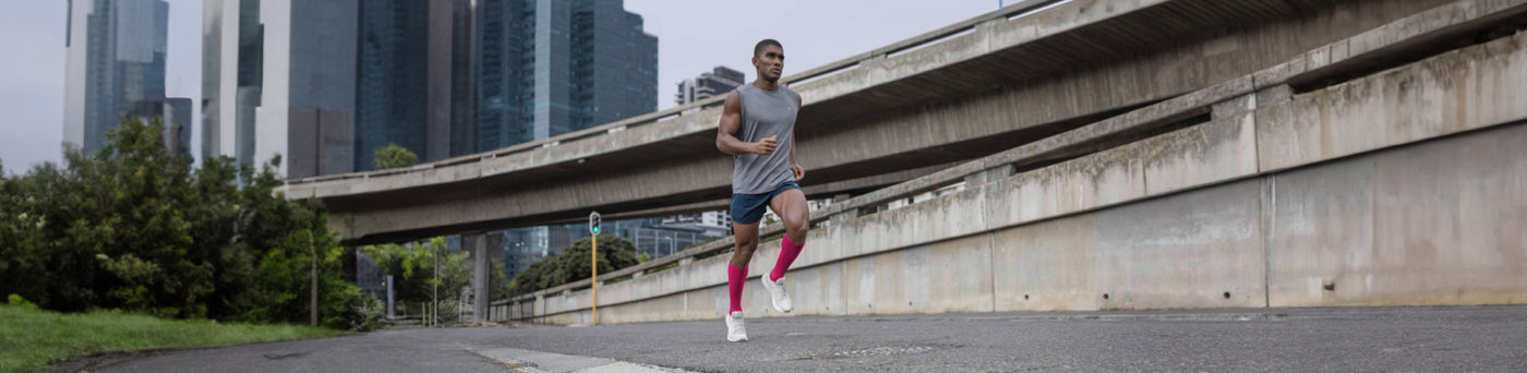 man running in Bauerfeind's Calf Compression Sleeves to avoid calf injuries and pain
