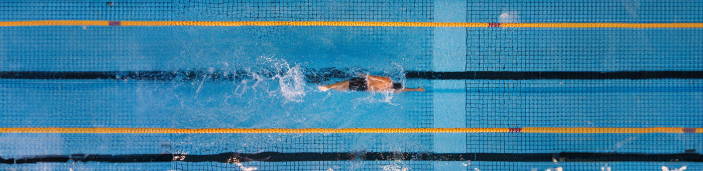 man swimming laps in the pool to get faster and more efficient in the water