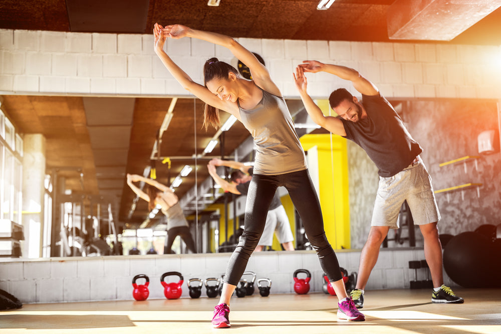 Gyms are back! Injury-free return to the gym. image of young couple stretching in the gym