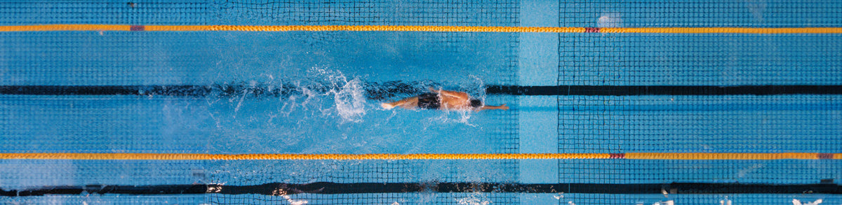 man swimming laps in the pool to get faster and more efficient in the water