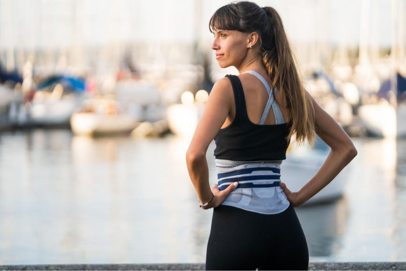 Woman at the bay wearing a LumboTrain back brace to manage chronic back pain