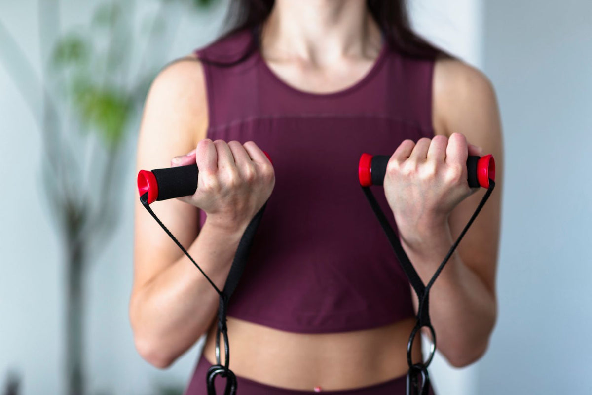 Woman preparing to perform the standing rows exercise with a resistance band